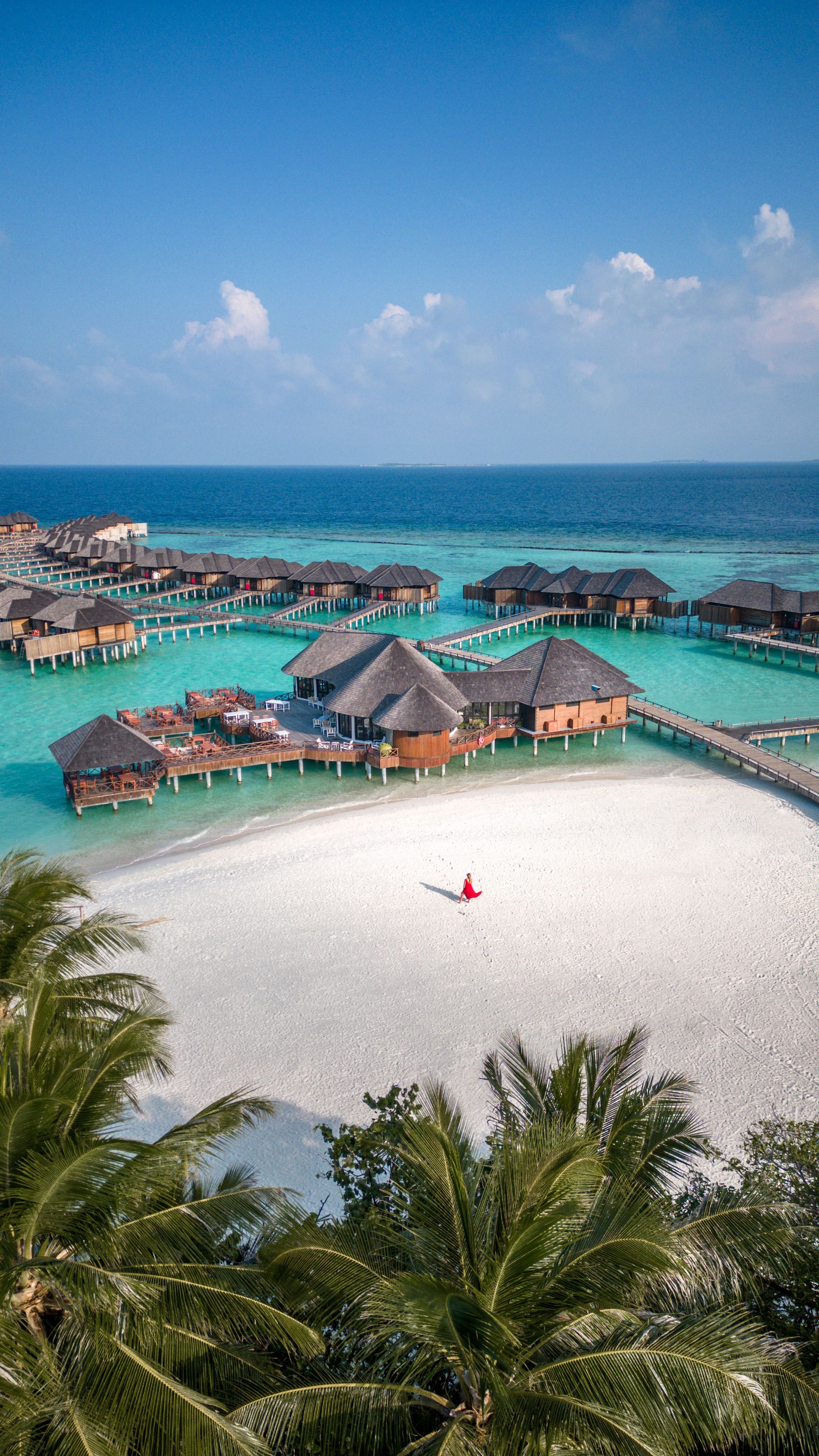 woman walking on beach at Maldives hotel lagoon and Beach on tropical Island Resort